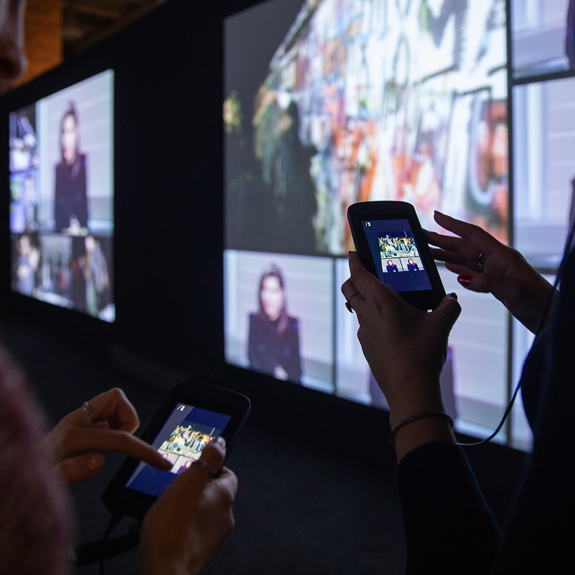 Two visitors using Imagineear Mirage multimedia guides at a Musealia exhibition